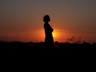 girl standing in the sunset