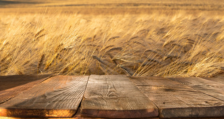 wood board table in front of field of wheat