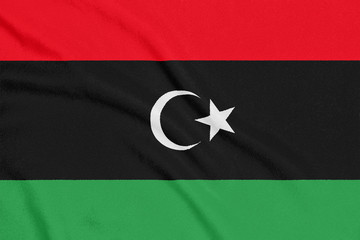 Flag of Libya on textured fabric. Patriotic symbol