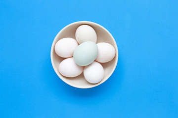 White eggs on blue background.