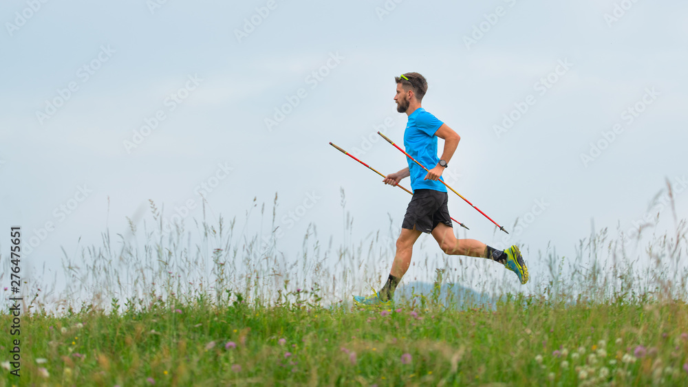 Wall mural Mountain runner during the preparation of a long distance trail