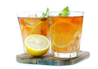 iced tea with lemon slices and mint on white background
