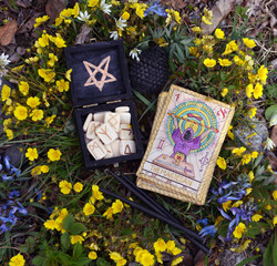 Witch runes, black candles and tarot cards.