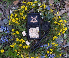 Witch box with white runes and black candles, top view.