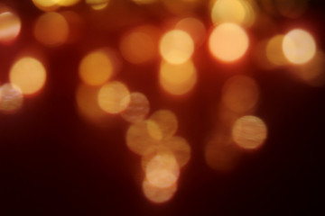 Abstract dark red and golden bokeh background holiday texture