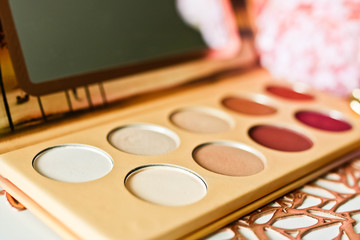 Colorful eyeshadow palette with mirror close up view. Trendy make up product.