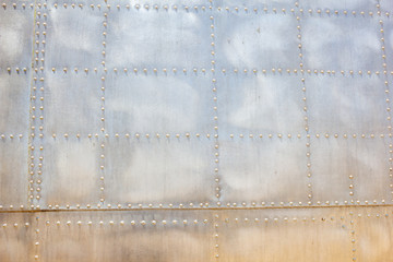 A background of a metallic aircraft body surface