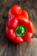 Top view on red pepper closeup on dark wooden background