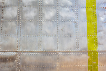 A background of a metallic aircraft body surface