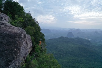 Aerial drone view of beautiful rocky mountain view point over breathtaking valley and cloudy sky background