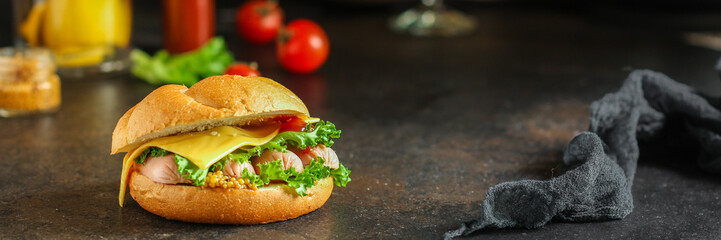 burger with sausages, cheese, lettuce, tomato sauce (snack sandwich, kaiser bun). top food background. copy space