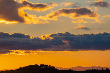 View of rolling countryside at sunset, Tuscany, Italy