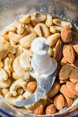 Cashew and almonds nuts in electric grinder with blades