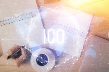 Cryptocurrency hologram over woman's hands writing background. Concept of blockchain. Double...