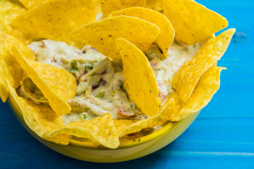 Tortilla chip made from corn tasty Tex-Mex food or snack on a wooden table.