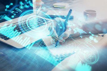 International business hologram over woman's hands taking notes background. Concept of success. Double exposure