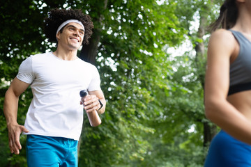 Happy couple running and jogging together outdoor