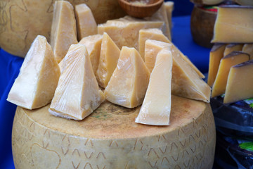 Parmesan cheese on a market stand. 