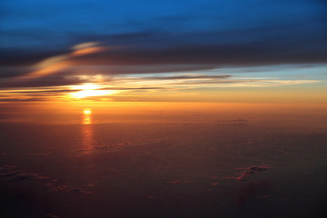 Fototapeta premium Aerial view from a plane of a scenic sunset above the Pacific ocean