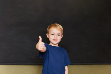 Boy posing with thumbs up