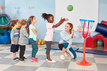Group of kids exercise basketball toss