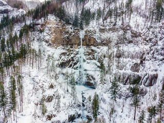 Aerial view of Multnomah Falls from above. View of a frozen waterfall after a massive snowfall in Columbia River Gorge