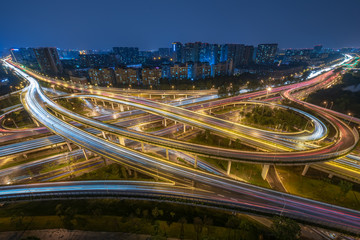 Large interchange with busy traffic aerial view at night in Chengdu, China