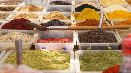 Various spices for sale in the bazaar. Close image of volorful spices in the boxes.