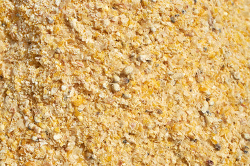 Background texture of crushed seed and grain mix for livestock and bird feed