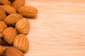 Almonds, large seeds on the wood, Close up.