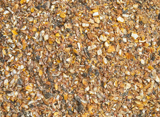 Background texture of crushed seed and grain mix for livestock and bird feed