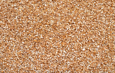 Background texture of crushed seed and grain mix for livestock and bird feed