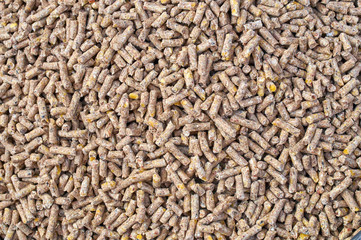 Background texture of crushed seed and grain mix for livestock and bird feed