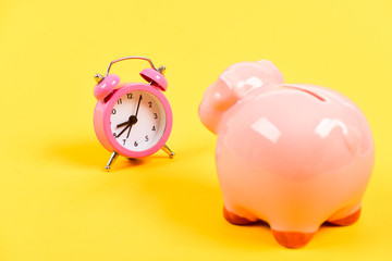 Time is money. Economy and budget increase. business startup. financial position. success in finance and commerce. retirement. family budget. piggy bank with alarm clock. Moneybox