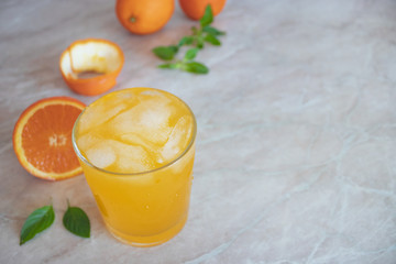 Orange juice on a white background. Fresh citrus cocktail with ice. Oranges and fresh mint. Cooling drink