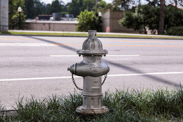 Atlanta, Georgia \ USA - 16 May 2019: Fire hydrant painted in silver color on a street. Hydrant 250WP by Mueller of Albertville, Alabama
