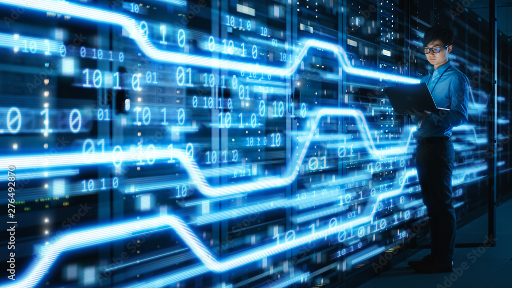 Poster Shot of Asian IT Specialist Using Laptop in Data Center Full of Rack Servers. Concept of High Speed Internet Connections with Blue Visualization Projection of Data Transmission with Digits.