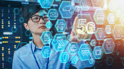 Shot of a Asian IT Engineer Touching 5G Icon in a Data Center Server Room. High Speed 5G Internet Concept with Different Computer Illustrative Icons and Symbols in the Foreground.