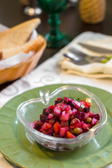Traditional Russian and Ukrainian vegetable salad Vinaigrette. Salad with beets, potatoes, carrots, pickles and peas.