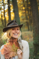 Sweet young sensual sexy woman walking in autumn park. Autumnal vogue trend. Autumn woman having fun at the park and smiling.