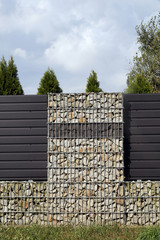 Stone wall-gabions. An unusual and and attractive type of house fencing.