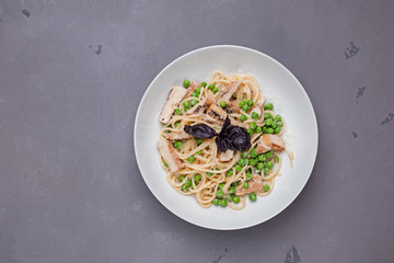 Green spring spaghetti with peas in white plate