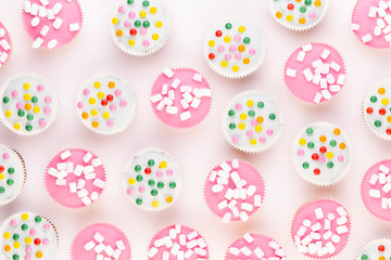 Colorful cupcakes on a white background.