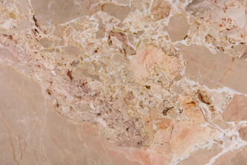 Abstract spots of different shapes and sizes of yellow color on a marble slab. Separate bathroom. The texture of natural marble.