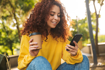 Happy young girl with red curly hair