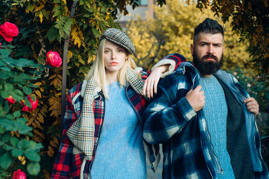 Hipster style. Man bearded hipster and girl wear kepi hat. Checkered style. Couple handsome bearded hipster and fashion girl. Lumberjack style. Couple wear checkered clothes nature background