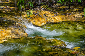 Naklejka na ściany i meble Waterfall green forest river stream landscape.