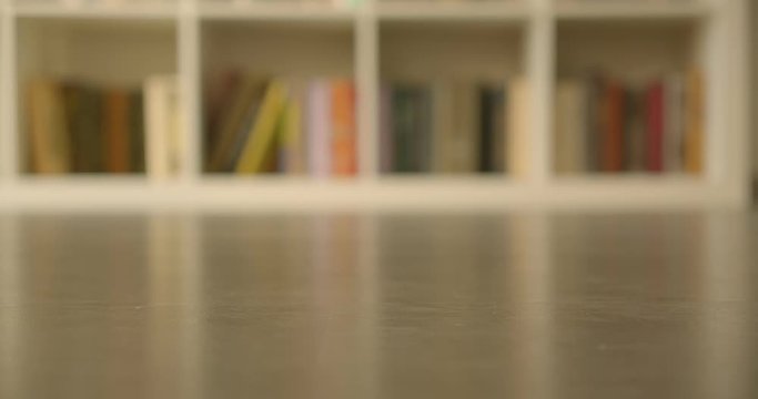 Shoot of the bookshelves with books in the library with modern interior indoors with blurred background