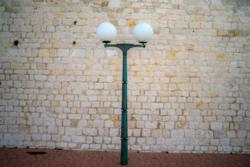 old street lamp on the stone wall