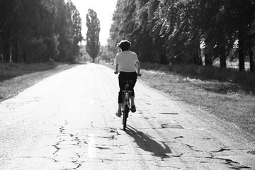 Happy girl rides a classic bike among beautiful nature.